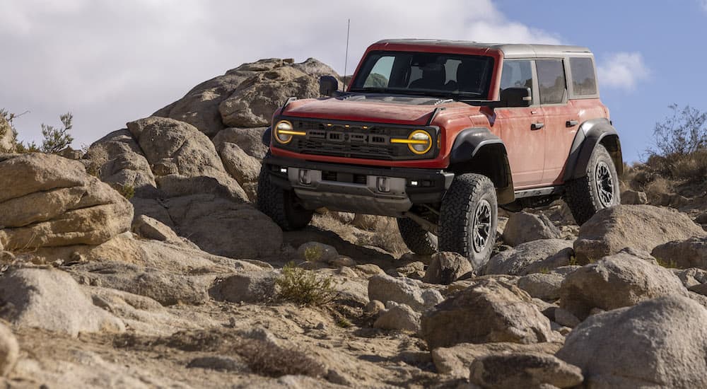 A red 2022 Ford Bronco Raptor is shown from the front at an angle.