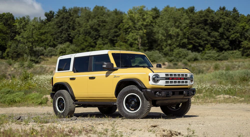 A yellow 2023 Ford Bronco Heritage Sasquatch is shown from the side after leaving a Ford dealer.