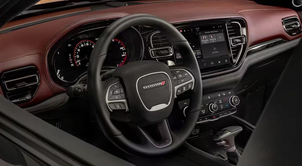 The black and brown interior and dash in a 2024 Dodge Durango is shown.