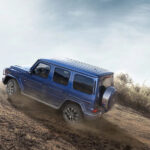 A blue 2024 Mercedes-Benz G Class is shown from the rear at an angle.