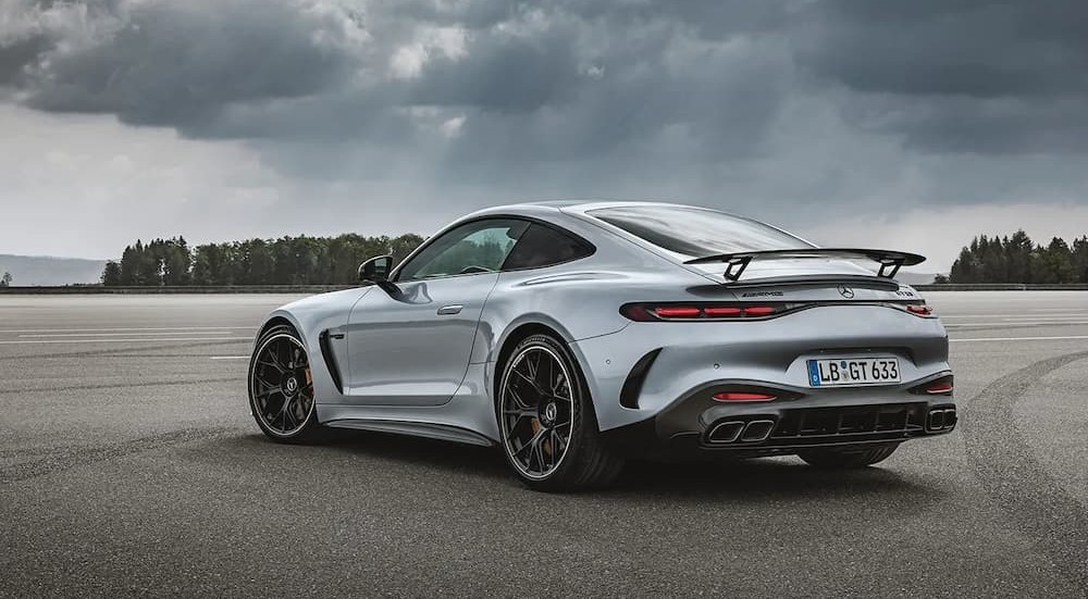 A silver 2024 Mercedes-AMG GT is shown parked on a cloudy day.