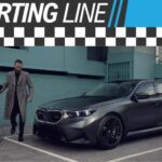 The Starting Line Banner is shown over a person and a black 2025 BMW M5.