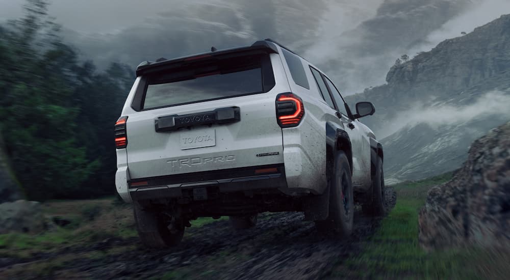 A white 2025 Toyota 4Runner TRD Pro is off-roading after leaving a Toyota dealer.