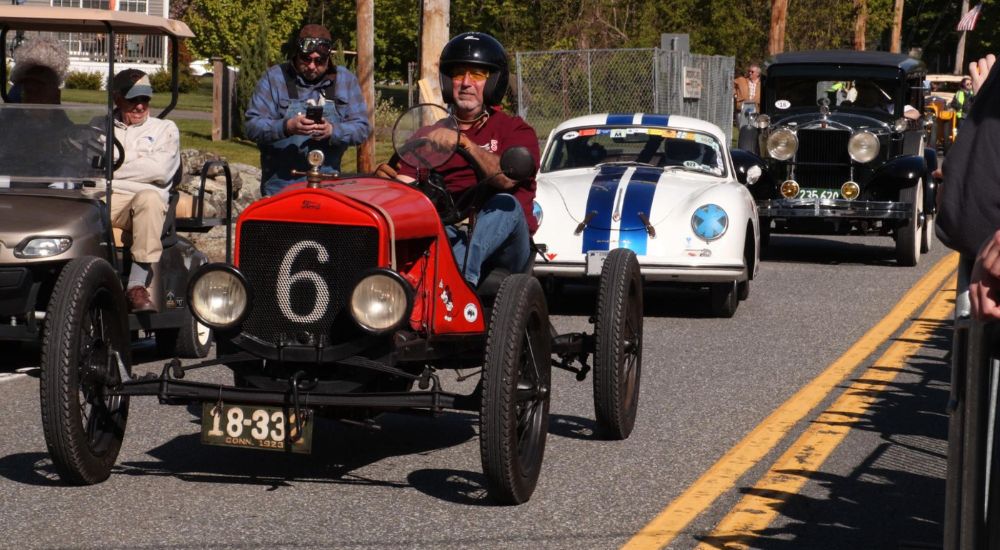 A red 1923 Model T, a white 1956 Porsche 356A, and black 1928 Hupmobile are shown at the Wilbraham Hill Climb.