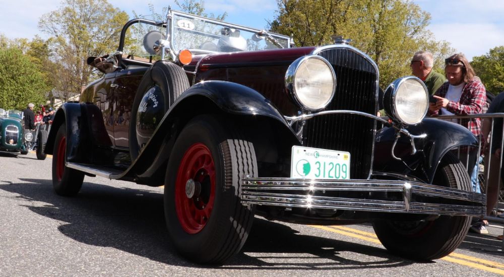 A black 1929 Chrysler Six Series 75 Roadster is shown from a low angle.