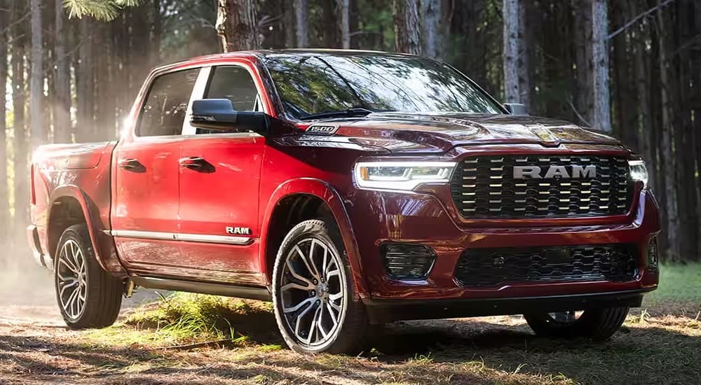 A red 2025 Ram 1500 Tungsten is shown from the front at an angle.