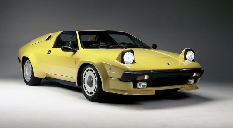 A yellow 1988 Lamborghini Jalpa is shown parked in a gray room.