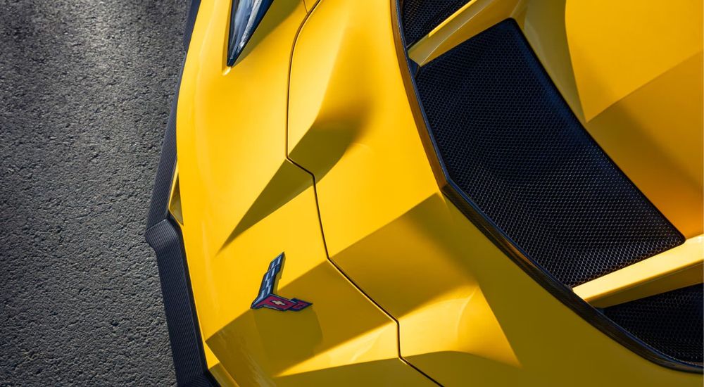 A close up shows the hood and front bumper in a yellow 2025 Chevy Corvette ZR1.