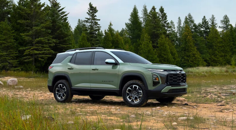 A green 2025 Chevy Equinox ACTIV is shown from the side while off-road after leaving a Chevy dealer.