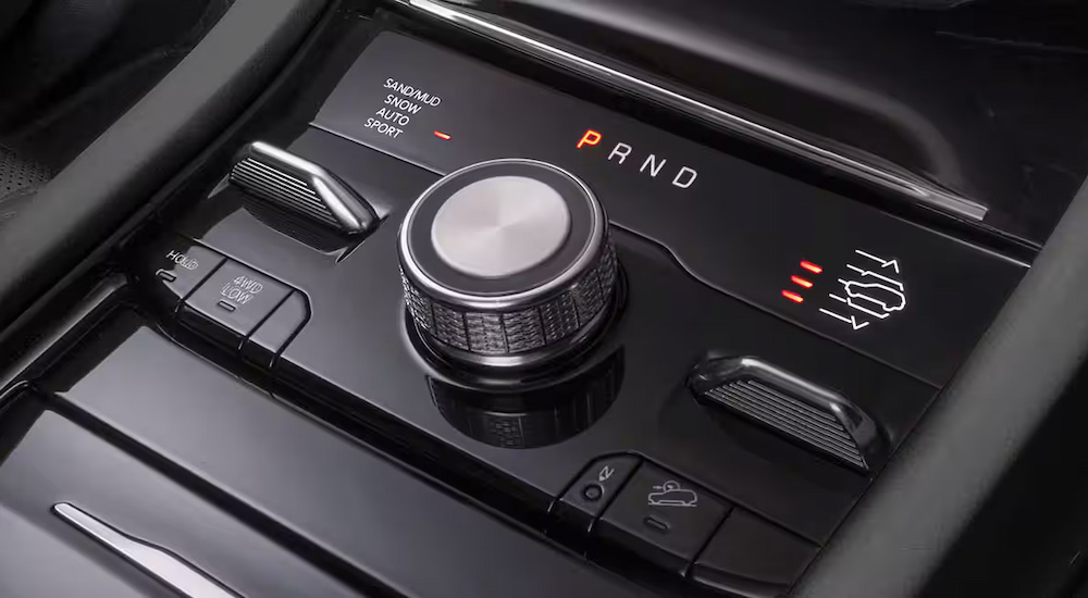 Close-up of the Selec-Terrain knob in a 2024 Jeep Grand Cherokee Trailhawk 4xe for sale.