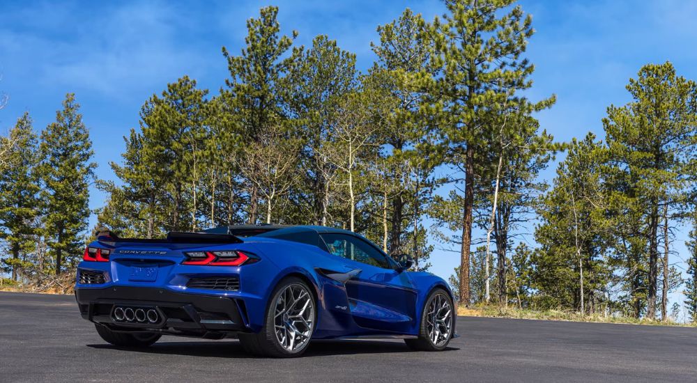 A blue 2025 Chevy Corvette ZR1 is shown from the rear parked on pavement.