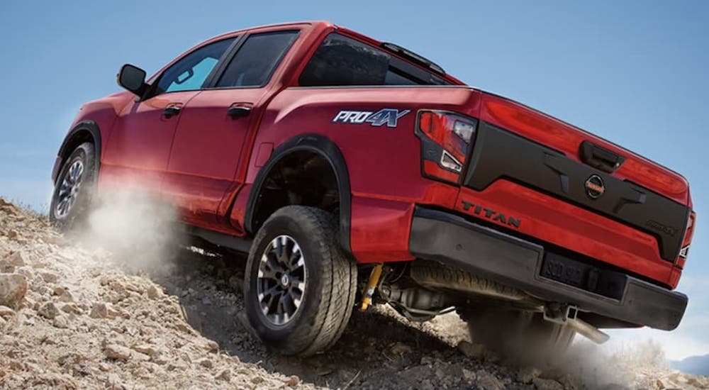 A red 2021 Nissan Titan PRO-4x is shown from the rear at an angle.