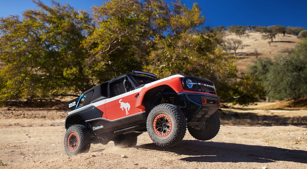 A red and black 2023 Ford Bronco DR driving off-road.