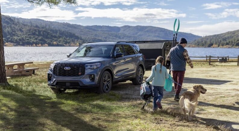 A gray 2025 Ford Explorer ST is shown parked near a lake.