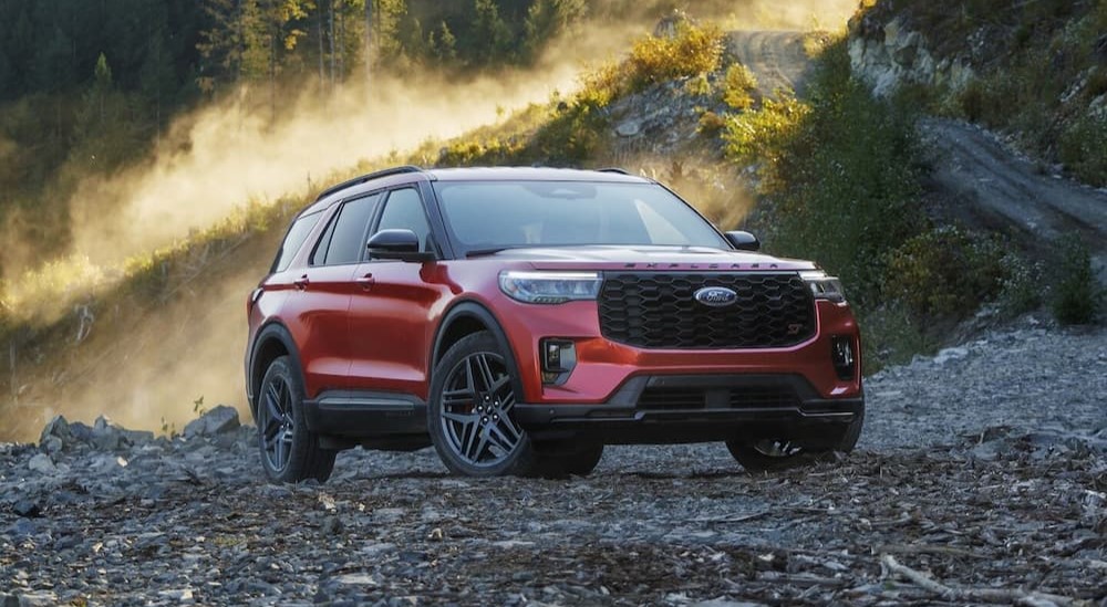 A popular Ford Explorer for sale, a red 2025 Ford Explorer ST, is shown parked off-road.