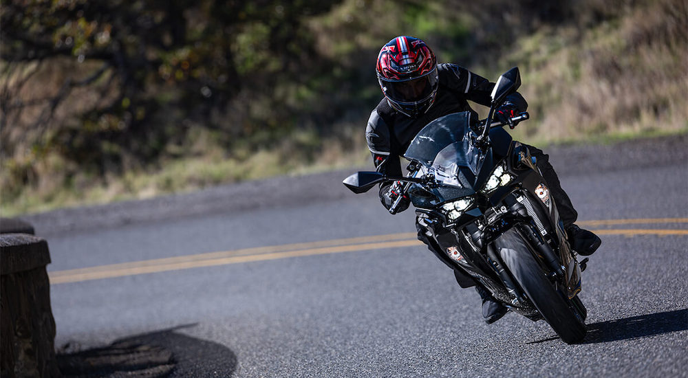 A black 2024 Kawasaki Ninja 500 is shown from the front.