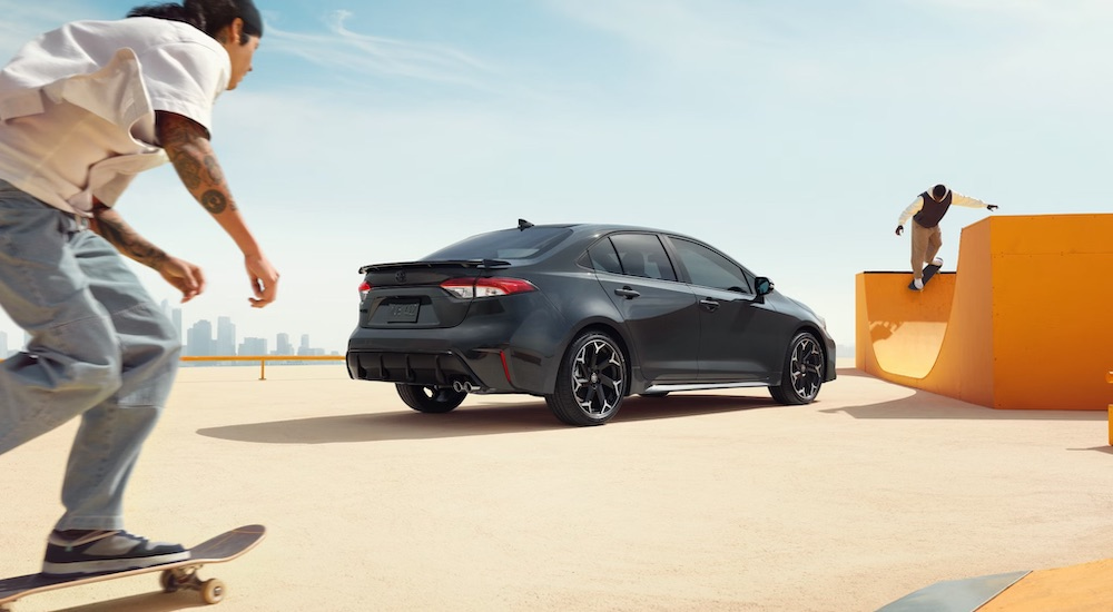 A grey 2025 Toyota Corolla for sale is shown from the rear at an angle.