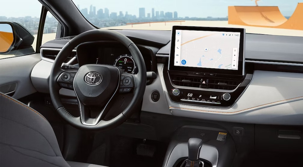 The grey interior of a 2025 Toyota Corolla FX is shown from the rear seats.