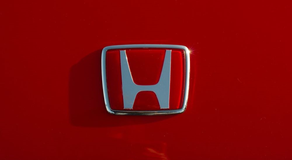 A close-up on a red Honda badge.