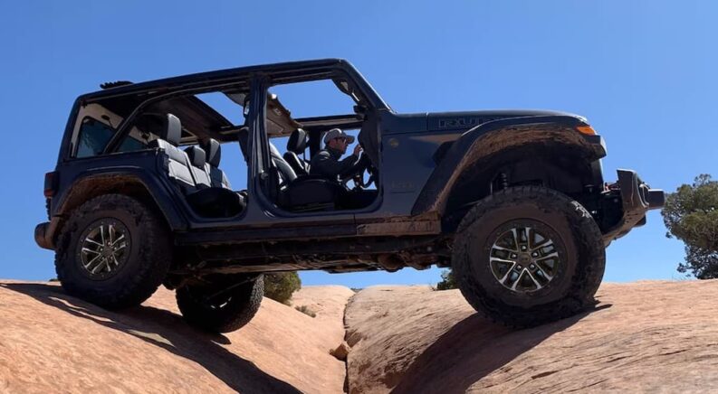 A grey 2024 Jeep Wrangler Rubicon X is shown from the side.