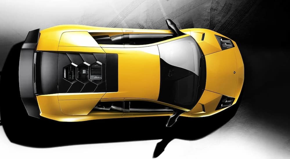 A yellow 2010 Lamborghini Murcielago SV is shown parked from an aerial view.