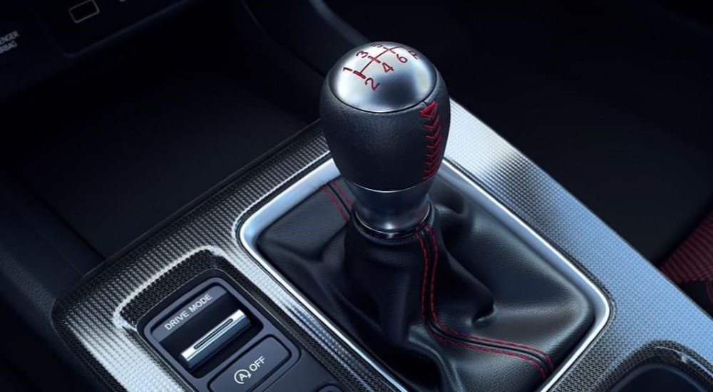 A manual stick shifter in the black interior of a 2023 Honda Civic Si.