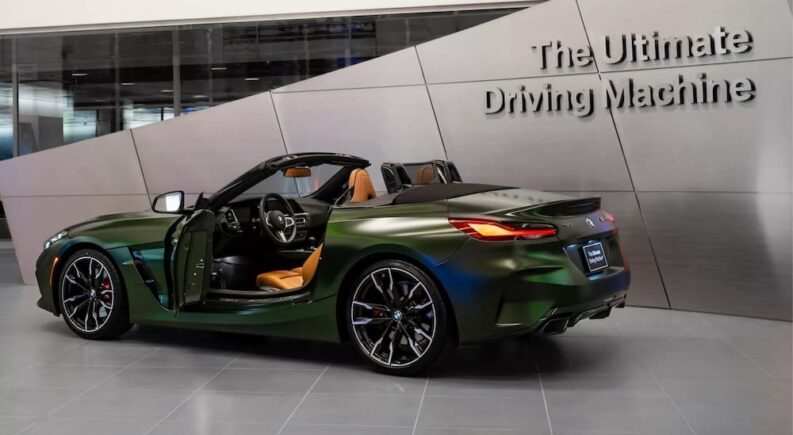 A green 2024 BMW Z4 M40i Roadster is shown parked in a building.