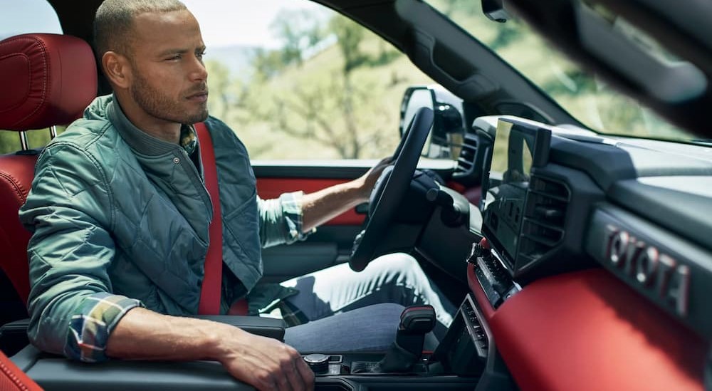 The black and red interior and dash are shown in a 2025 Toyota Tundra TRD Pro.