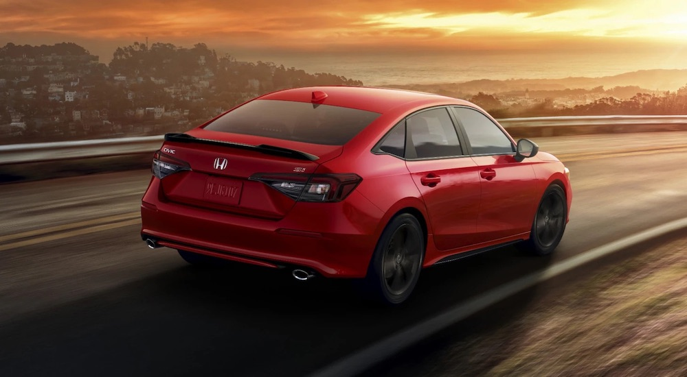 A red 2025 Honda Civic Si is shown from the rear at an angle.