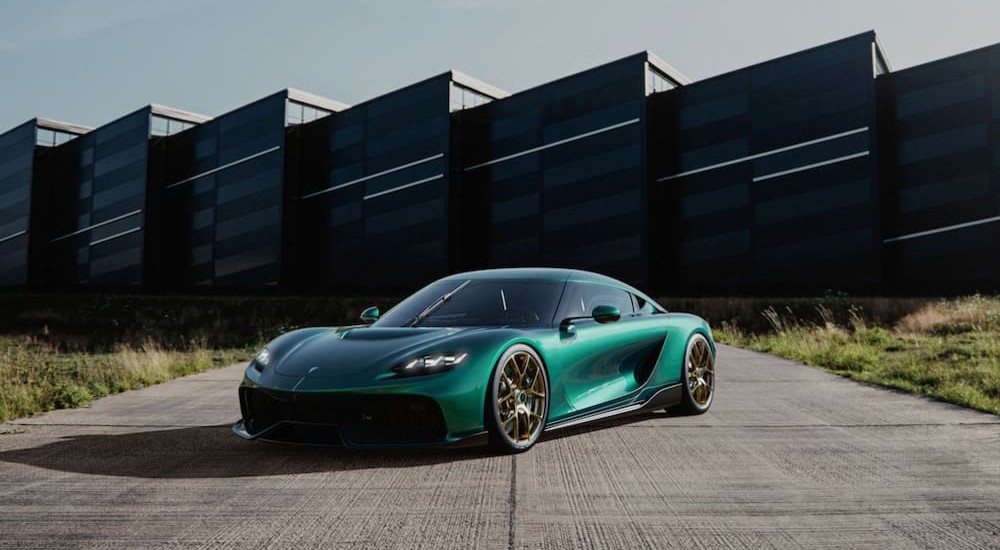 A green 2024 Koenigsegg Gemera is shown parked near a building.