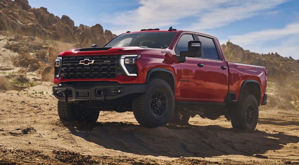 A red 2025 Chevy Silverado 2500 ZR2 is shown parked off-road.