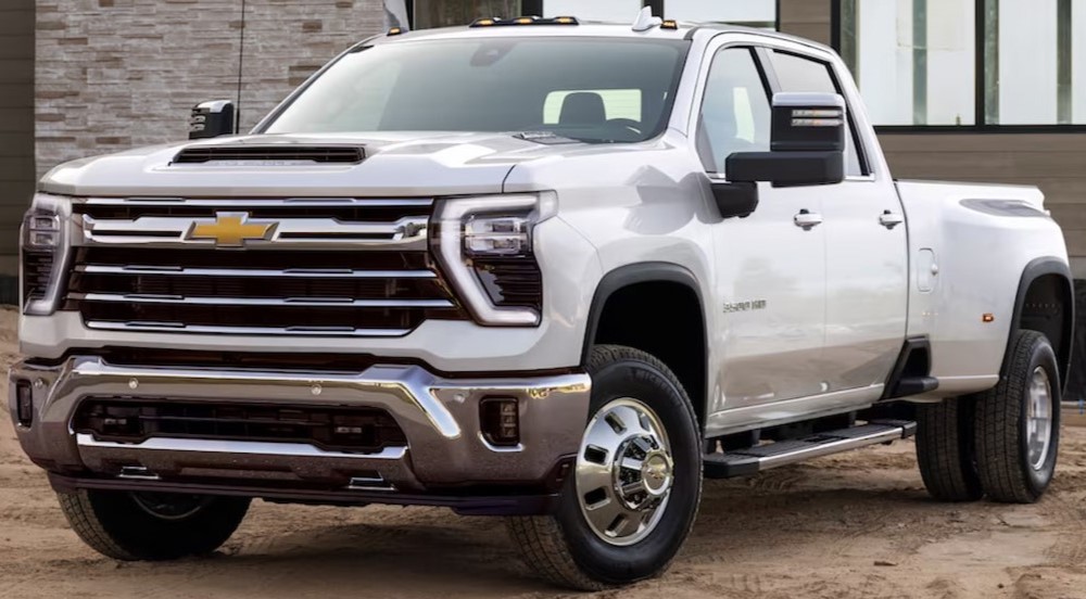 A white 2025 Chevy Silverado 3500 HD is shown parked on a construction site.