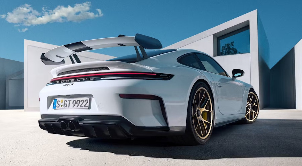 A white 2025 Porsche 911 GT3 is shown from the rear at an angle.