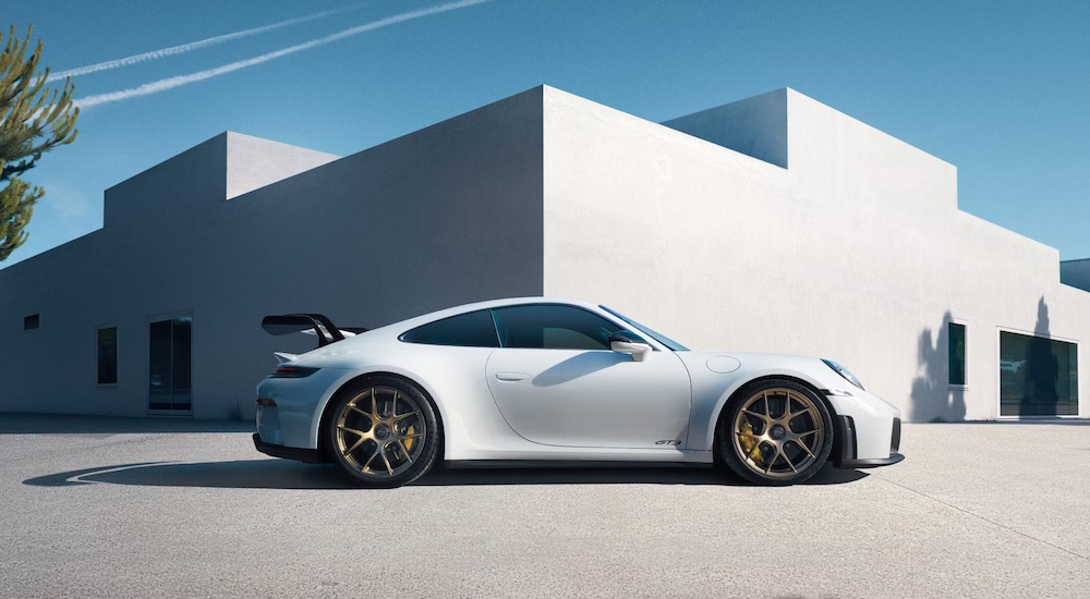 A white 2025 Porsche 911 GT3 is shown from the side.