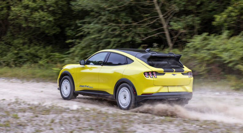 A yellow 2024 Ford Mustang Mach-E Rally is shown from the rear at an angle.