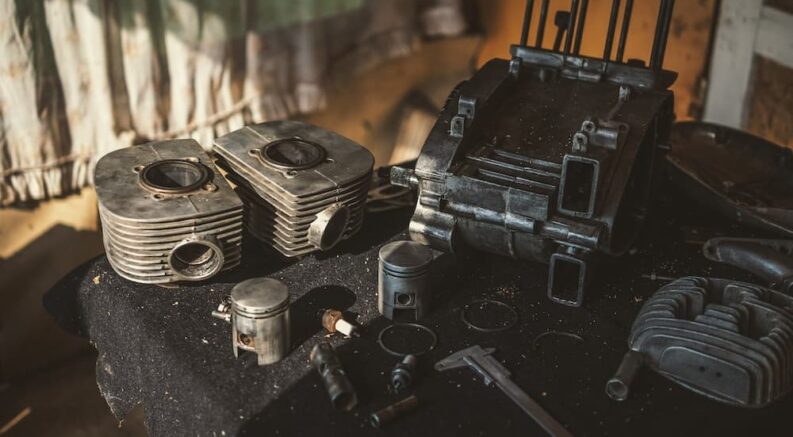 A motorcycle engine is shown taken apart.