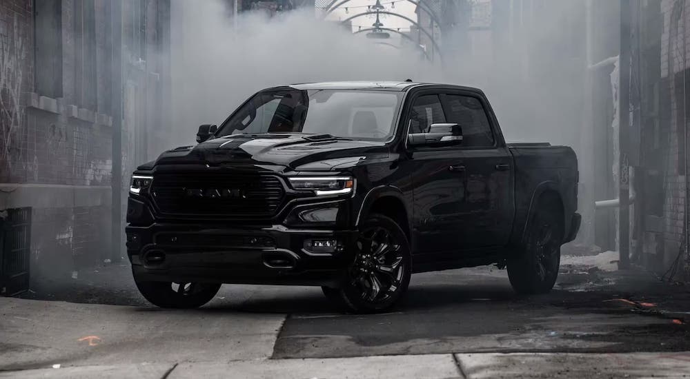 A black 2023 Ram 1500 parked in an alley and angled left.