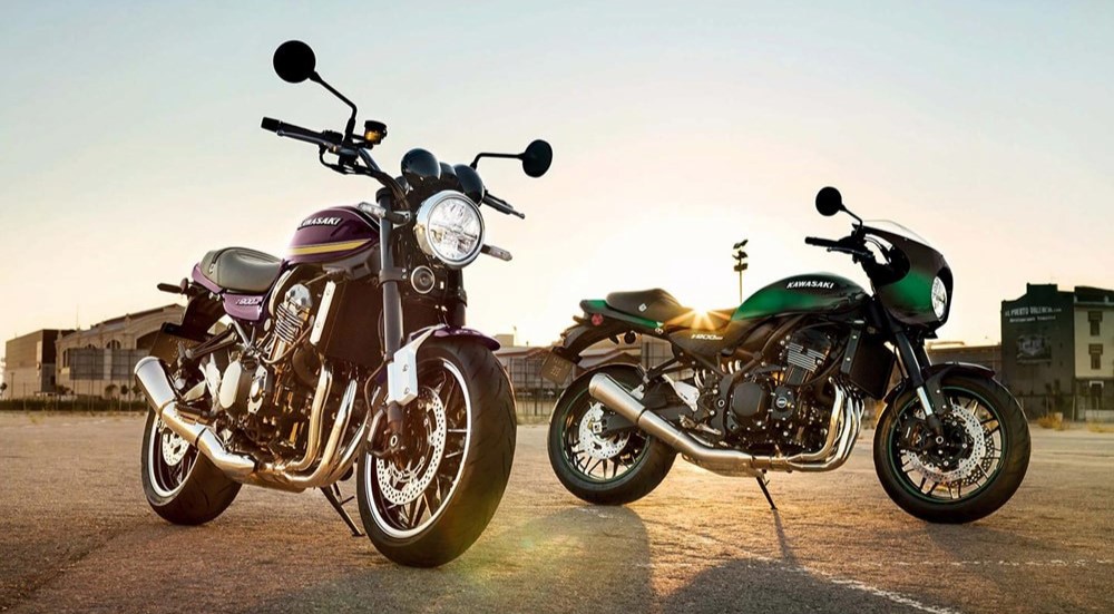 A purple and a green 2024 Kawasaki Z900RS are shown parked.