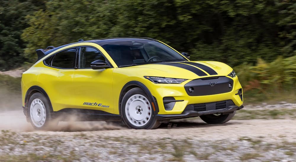 A yellow 2024 Ford Mustang Mach-E GT Rally Edition kicking up dust.