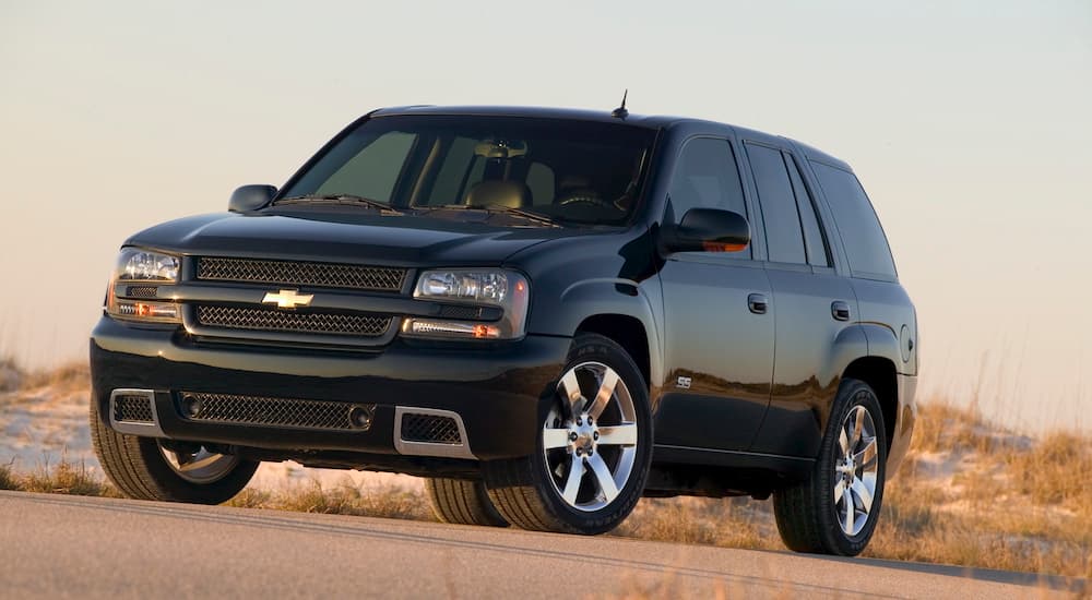 A black 2009 Chevy Trailblazer SS is shown parked near a beach.