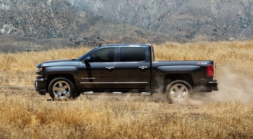 A black 2018 Chevy Silverado 1500 LTZ Z71 is shown driving off-road.