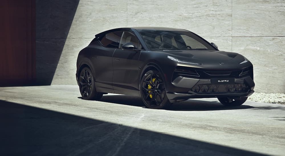 A black 2023 Lotus Eletre is shown parked on a driveway.