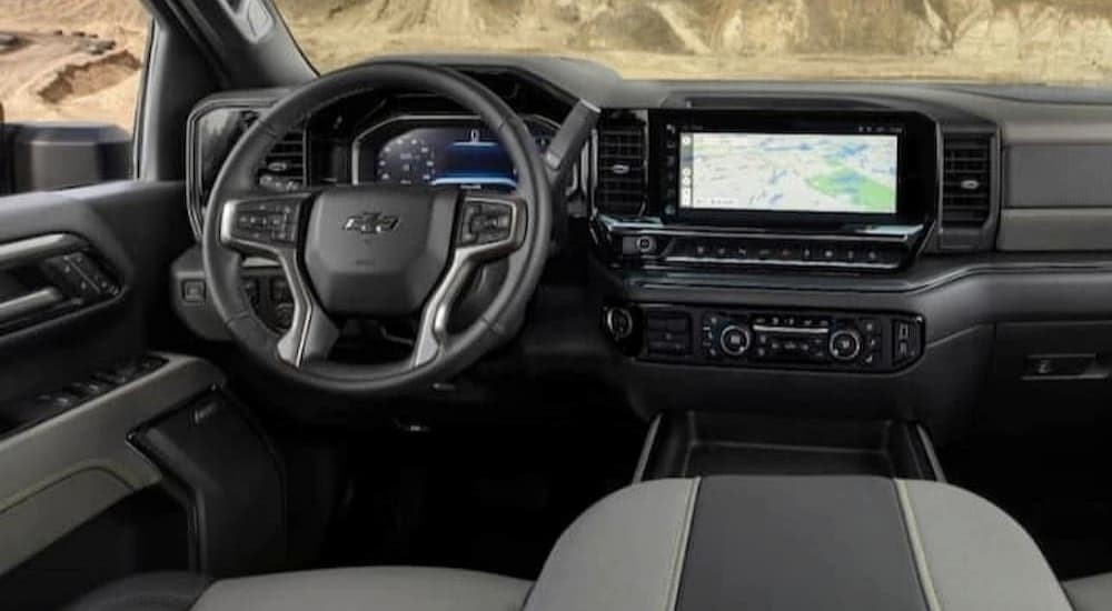 The gray and black interior and dash are shown in a 2024 Chevy Silverado 1500 ZR2.