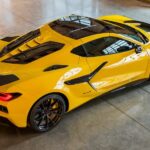 A yellow 2025 Chevy Corvette ZR1 is shown parked at a Chevy dealer.