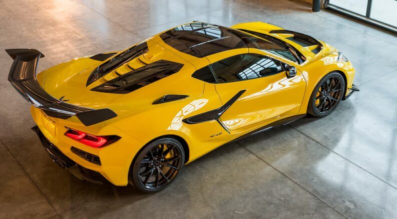 A yellow 2025 Chevy Corvette ZR1 is shown parked at a Chevy dealer.