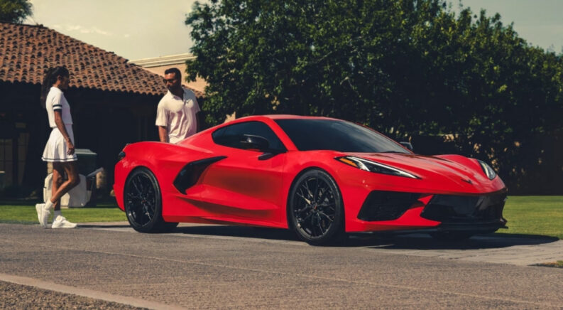 A red 2025 Chevy Corvette Stingray is shown after leaving a Chevy dealer.