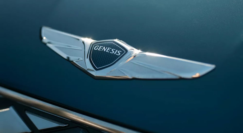 A close-up of the Genesis badge is shown.