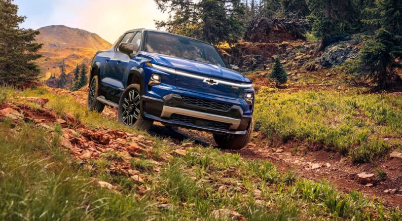 A blue 2025 Chevy Silverado EV RST is shown from the front at an angle.