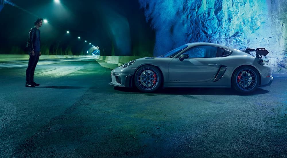 A gray 2025 Porsche 718 Cayman GT4 RS is shown parked in a tunnel.