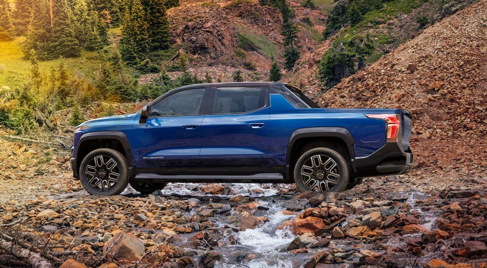 A blue 2025 Chevy Silverado EV for sale is shown from the side.